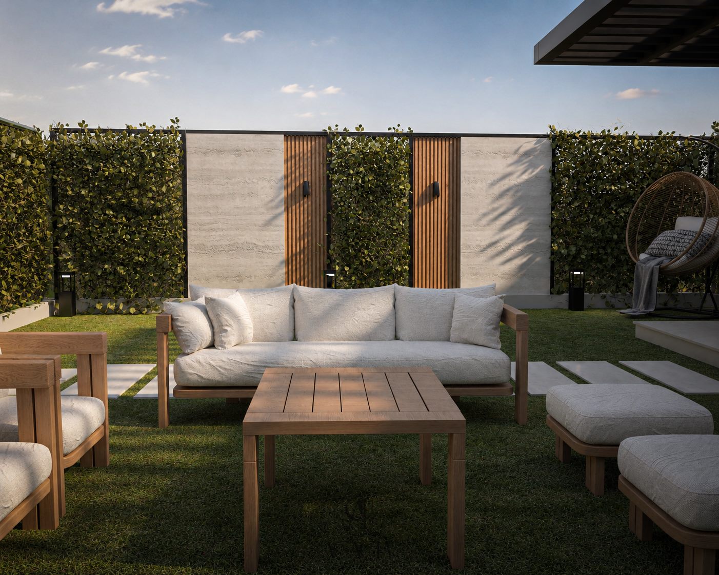 Upville garden lounge with layered travertine, wood, and hedge privacy screen by Acacia Zone
